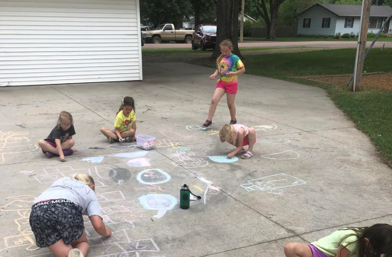 Picture of Kids playing with sidewalk chalk at Kids Club Summer Program